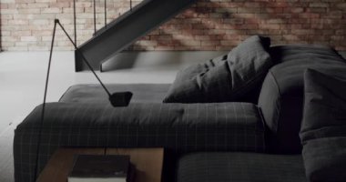 Modern contemporary Minimalist living room with bricks wall, large sliding windows and gray fabric furniture. Luxury Modern House Interior With Corner Sofa and Bookshelf. Fashionable furniture.