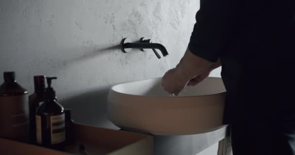Man Washes His Hands Luxury Bathroom Interior Black Gray White — Vídeo de stock