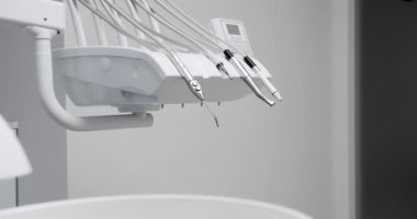 Modern Room with dental chair and medical equipment. Dental equipment at dental office, chair and other accessories. Dental clinic equipment.