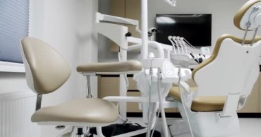 Modern Room with dental chair and medical equipment. Modern Dental office. Dental equipment at dental office and chair and other accessories.