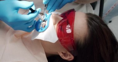 Oral hygiene and prophylactic cleaning. Female patient at hygiene teeth cleaning procedure in dentistry. Dentist making tooth cleaning for patient in dental modern clinic. Modern dental clinic.