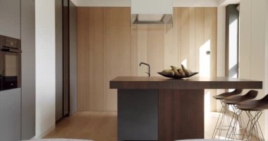 Beautiful kitchen interior with new stylish furniture. Real kitchen with an island. Modern interior in luxury house. Interior of a minimalist kitchen. Modern Kitchen room with minimalist dining table.