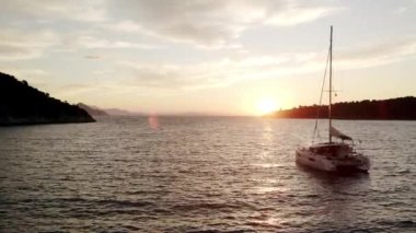 Luxury cruise trip. View from above of white boat on deep blue water. Yachting. Luxury Sail boat . Sailboat. Aerial top down view of rich yacht sailing sea. Summer journey on luxury ship.
