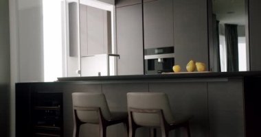 Minimalist Real Apartment. Modern Kitchen Room. Minimalist Furniture with Dining table with modern chairs. Modern Chrome Faucet. New Home. Real Luxury Design Interior. Neoclassic Style, cozy interior.
