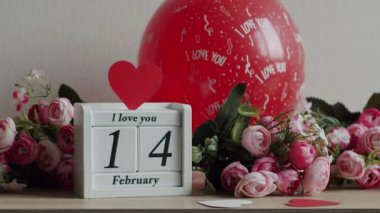 Happy Valentines Day. 14 February Valentines Day idea. Calendar with the date February 14 and the inscription I love you, with pink rose flowers and many hearts.