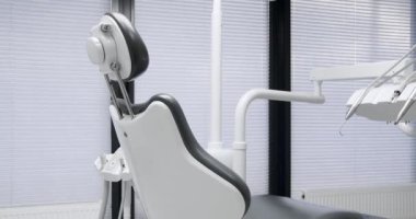 Modern Room with dental chair and medical equipment. Equipment at dental office. Modern dental practice. Dental chair and other accessories.