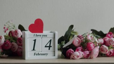 Happy Valentines Day. 14 February Valentines Day idea. Calendar with the date February 14 and the inscription I love you, with pink rose flowers and many hearts.