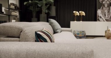Modern contemporary Minimalist living room with beige furniture. Luxury Modern House Interior With Corner Sofa, Chairs and Bookshelf. Fashionable furniture. Minimalist Home Interior. Real Estate