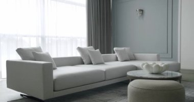 Modern contemporary Minimalist living room with white and gray furniture and round table. Luxury Modern House Interior With Corner Sofa. Minimalist Home Interior. Modern Furniture Design. Elegant Room