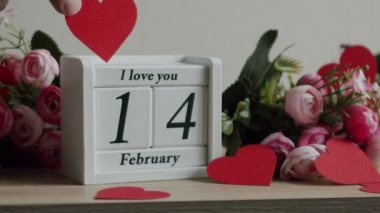 Happy Valentines Day. 14 February Valentines Day idea. Calendar with the date February 14 and the inscription I love you, with pink rose flowers and many hearts.