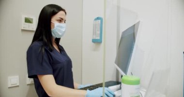 Female doctor examines and prepares the diagnostic machine in the hospital, and works on the computer and examines the tests. Diagnosis of breast cancer. Mammography device in a modern hospital.