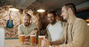 Fans watching football in a bar with friends, football, hockey, basketball, sports games. Soccer fans celebrating victory of team in sports bar Loyal football fans supporting their team.