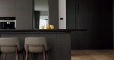 Minimalist Real Apartment. Modern Kitchen Room. Minimalist Furniture with Dining table with modern chairs. Modern Chrome Faucet. New Home. Real Luxury Design Interior. Neoclassic Style, cozy interior.