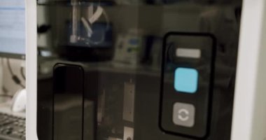 Blood Testing Machine Checks Samples In A Laboratory Room. Automated machine in work process, blood and urine sampleanalysis. Bio lab medical clinic chemical automatic analyzer.