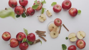 Kırmızı elmalar, ikiye bölünmüş meyve, beyaz arka planda izole edilmiş meyve, malus domestica, meyveli patlayan beyaz arka plan, dilimlenmiş kırmızı doğal elma, tarçın, stüdyo çekiminde çiğ yemek.