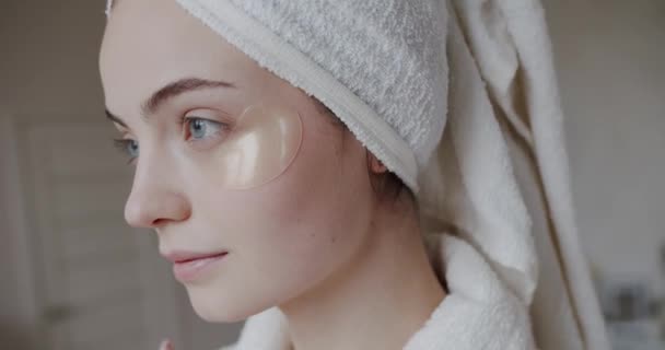 美容業界の顔のケア若返りの概念 皮膚の若返りの女性は目のパッチの下に直面する パッチを使用して目の皮膚の下で保湿女性の肖像画 完璧なきれいな新鮮なスキンケア治療 — ストック動画