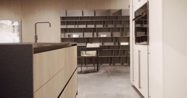 Modern wooden kitchen room furniture. Elegant, Comfortable and Minimalist Home. Domestic Kitchen with modern black sink. Modern Kitchen room with minimalist dining table. Modern Minimalist Home.