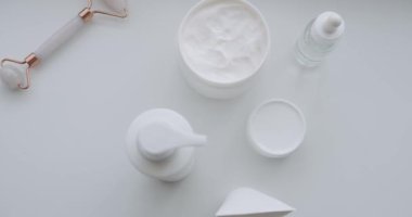 Doğal kozmetik ürünleri, cilt bakım ürünleri. İçinde jöle, sıvı, kolajen serumu, yağ, krem ve losyon olan bir şişe. Cilt masajı için kozmetik ürünleri ve süngerlerle dolu şişeler..
