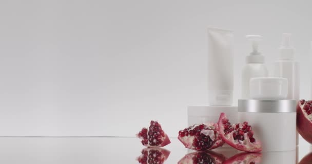 White Bottle Tubes Pomegranate Fruits Cosmetics White Background Studio Natural — Stock Video