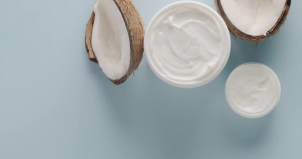 Witte Flessen Tubes Met Kokosnoot Voor Cosmetica Draaiend Een Lichtblauwe — Stockvideo