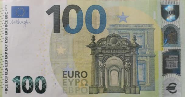 正面に100ユーロ札の動きをズームします １００ユーロの現金 動きのシームレスループ映像を停止します 100ユーロのキャッシュマクロビュー 背景ビル サイン マネー 金融危機 — ストック動画