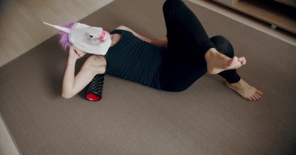 Funny Man Unicorn Mask Doing Back Exercise Roller Myofascial Relaxation — Stock Video