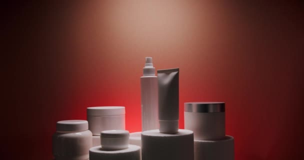 Botella Blanca Tubos Para Cosméticos Fondo Rojo Estudio Luz Aparece — Vídeo de stock