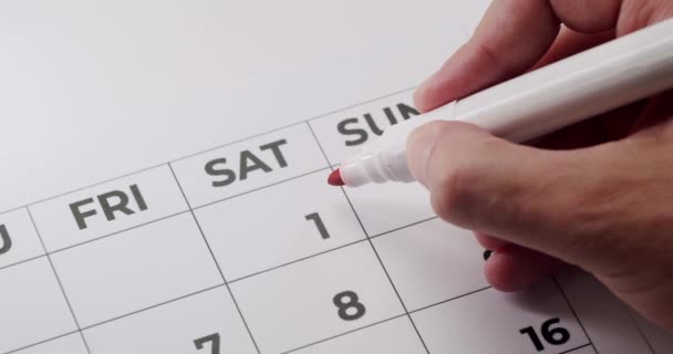 Closeup Man Hand Cross Out First Day Month Paper Calendar — Stock Video