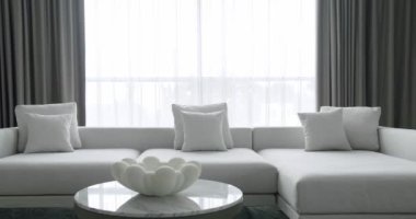 Modern contemporary Minimalist living room with white and gray furniture and round table. Fashionable furniture. Minimalist Home Interior. Cozy Modern Furniture Design. Luxury Elegant Room