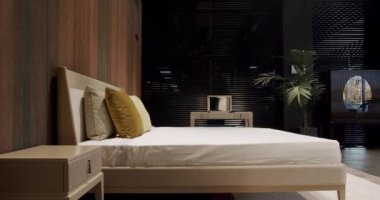 Elegance interior design. Minimalist Bedroom. Elegant and Simple Bedroom With a King Sized Bed. Interior with wood on the wall. Real Estate. Interior of modern luxury bedroom with furniture.