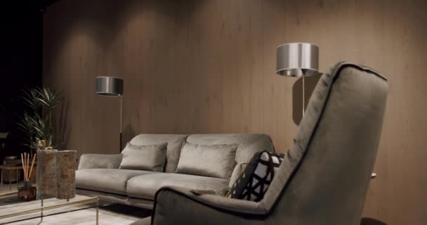 現代のミニマリストのリビングルームは 灰色の家具と木製の壁が備わっています コーナーソファーと椅子 居心地の良いモダンな家具デザインの豪華なモダンハウスインテリア 不動産プライベートホーム — ストック動画