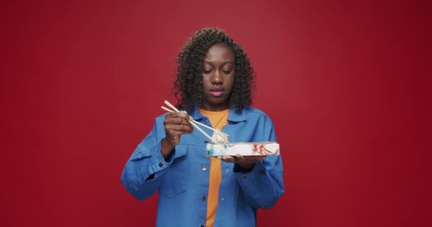 Afroamerykanka Patrzy Kamerę Uśmiecha Się Przygotowując Się Jedzenia Sushi Pałeczkami — Wideo stockowe