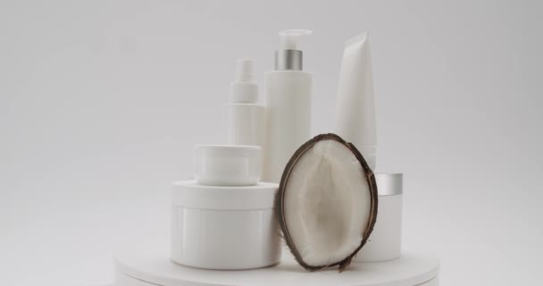 White Bottles Tubes Coconut Rotate Cosmetics White Background Studio Cosmetics — Stock Video