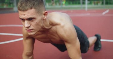 Dışarıda kas antrenmanı yapan genç bir erkek. Fitness ve sağlıklı yaşam tarzı konsepti. Sağlıklı yaşam için çalışıyor. Spor ve spor yaşam tarzı. Spor, spor rutini, egzersiz. motivasyon.