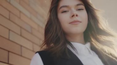 Şehir güneşinde duran kendine güvenen genç bir kadının portresi çağdaş kentsel iş tarzını ve zarafeti temsil ediyor. Şehir Işığında Kendine Güvenen Genç Kadın, Şehir İş Biçimi