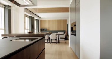 Modern contemporary Minimalist living room with wooden wall and gray furniture. Luxury Modern House Interior With Corner Sofa and Bookshelf. Fashionable furniture. Minimalist Home Interior.