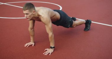Young male with muscular body training outside. Fitness and healthy lifestyle concept. Outdoor Fitness Park. Working out for good health. Fitness and sport lifestyle. Sports, health care,