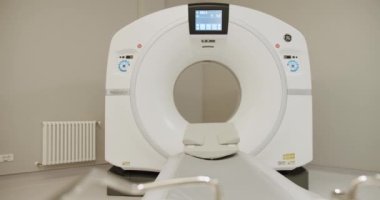 Magnetic Resonance Imaging machine. Hospital room with tomograph. Modern technologies in medicine. Shot Of Empty CT Scanning Room. Functioning MRI machine in a medical room.