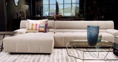 Modern masa, beyaz kumaş kanepe ve depolama mobilyalarıyla İskandinav iç mimarisi. Minimalist ve modern oturma odası. Yastıklı tekstil döşeme kanepesi. Modern koltukla iç içe..