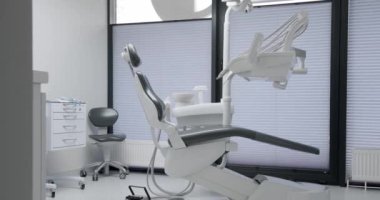 Modern Room with dental chair and medical equipment. Modern dental practice. Dental chair and other accessories. Dental clinic equipment.