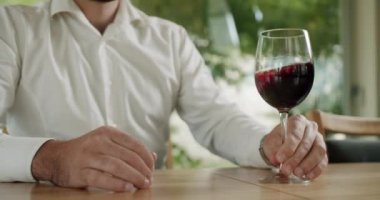 Camların dönüşü şarabın yüzeyini dalgalandırıyor ve uzun cam duvarlar boyunca uzanıyor. Zarif giyimli adam bir tat alıyor ve şeffaf bardağa dökülen taze kırmızı şarabı içiyor..