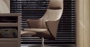 Minimalist kahverengi koltuk. Zarif ve rahat bir koltuk, sıcak ve rahat. Tasarımcı koltuğu. Modern daire. Modern kahverengi deri koltuk. Modern minimalist ev.