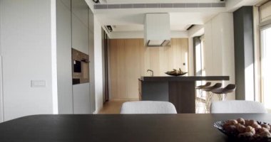 Yeni moda mobilyalarla dolu güzel bir mutfak. Lüks evde modern iç mekan. Minimalist bir mutfağın içinde. Açık Ahşap Duvar ve Zemin. Modern lavabolu Ev Mutfağı.