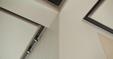 Modern bir evde minimalist estetiğe sahip duvarların ve tavanın karmaşık bağlantısını gösteren yakın plan bir bakış açısı. Modern Mimari Elementler ve İç Tasarım Detayları