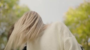 Gülümseyen bir çift bir ağacın altında sevgi dolu bir kucaklaşmayı paylaşır, güneşli bir sonbahar gününde sıcaklığı ve sevgiyi somutlaştırırlar. Romantik çift, birlikte sıcak bir sonbahar gününün tadını çıkarıyor.