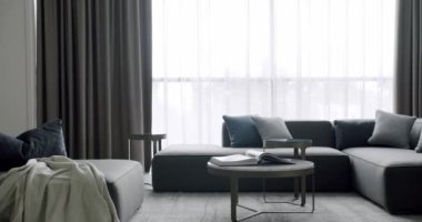 Modern contemporary Minimalist living room with gray furniture. Luxury Modern House Interior With Corner Sofa round table. Fashionable furniture. Minimalist Home Interior. Cozy Modern Furniture Design