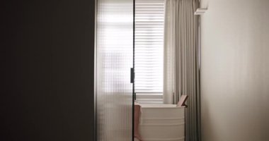 Luxury Bathroom Interior, minimalist interior in white colors with bathroom accessories , transparent door, round mirror in modern interior, bathtub modern design. Luxury cozy white Apartment.