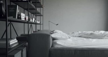 Elegance interior design with black and white colors. Minimalistic scandinavian style of interior. Interior with bookshelf on the wall. Real Estate. Interior of modern luxury bedroom with furniture.