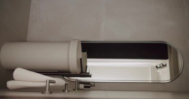 Temiz hatları, büyük bir aynası ve zarif tasarım unsurları olan modern minimalist bir banyo. Modern iç tasarım kavramlarını ve mimari fotoğrafçılığı sergilemek için mükemmel. Dikey