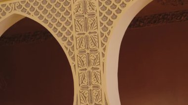 Süslü Fas kemerlerine ve detaylı oymalara yakından bakın. Sıcak, dünyevi tonlar sakin ve egzotik bir ortam yaratır. Seyahat, mimari veya kültürel projeler için mükemmel..